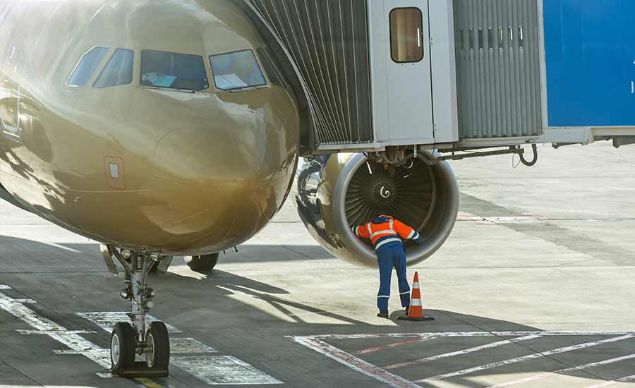 A person standing in front of a plane​