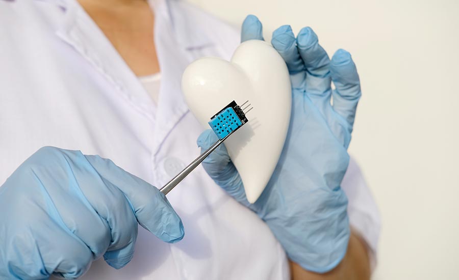 A person holding a heart with a microchip​