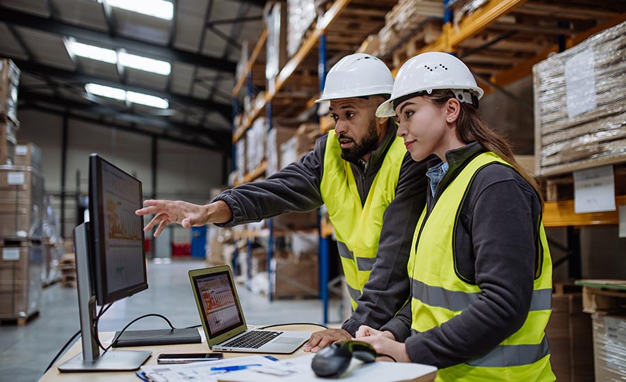 Two workers working on a computer​